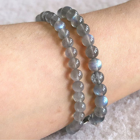 Stacking two sizes of Labradorite beaded bracelets. High-quality crystal jewelry for protection and change. Shokoro Canada.