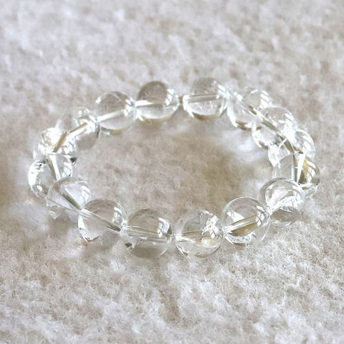 Samadhi crystal beaded bracelet on a soft white textured surface, creating a simple and elegant look. Beautiful and elegant.