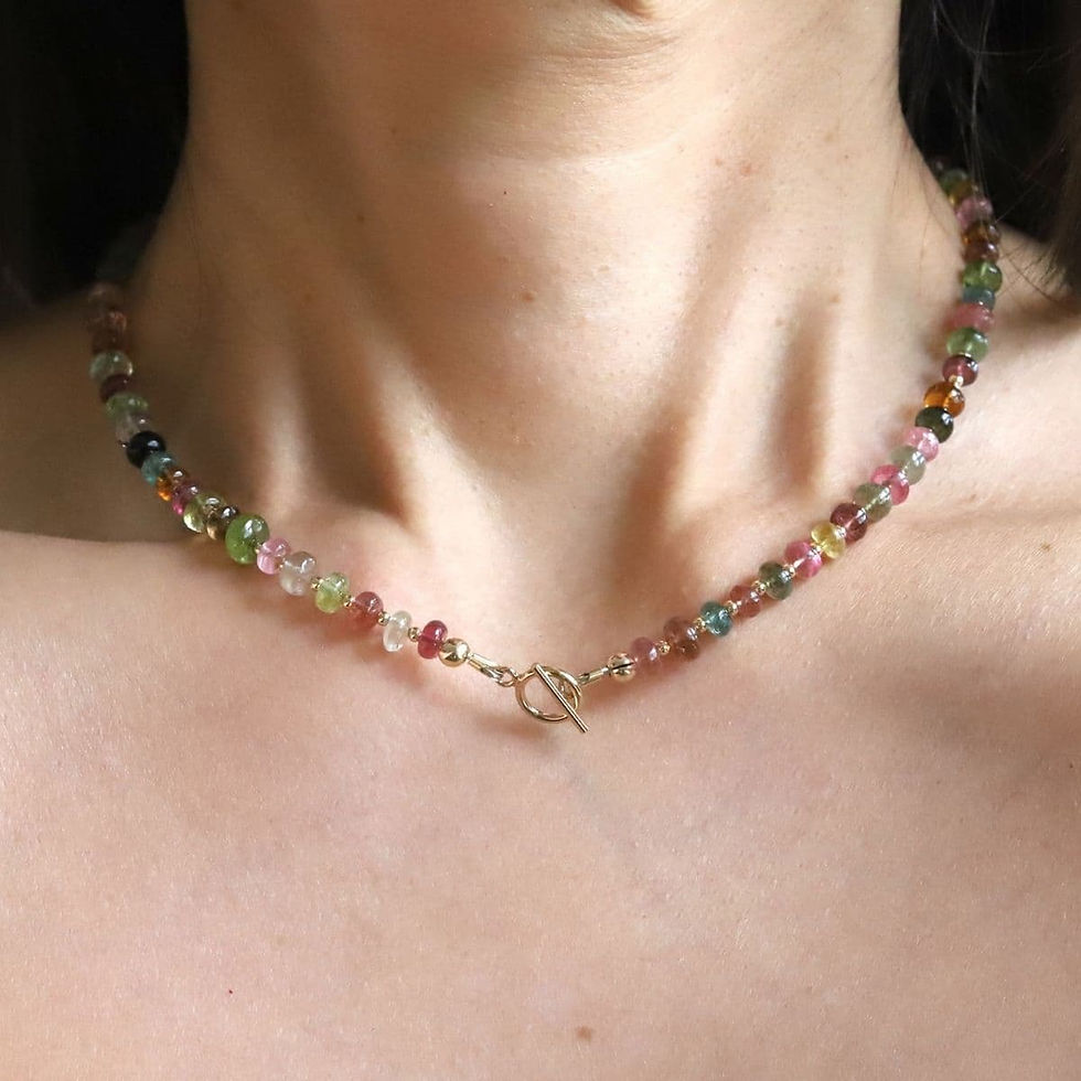 Wearing Multicolor Rainbow Tourmaline toggle necklace in 14k gold filled, showcasing artisan detail and quiet luxury style.