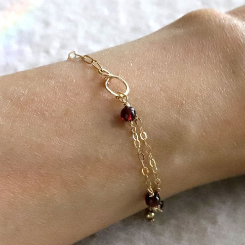 Wearing 14k gold filled handmade infinity 8 hammered link and garnet mixed chain bracelet, layered intention gift for her.