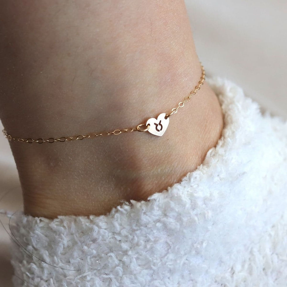 Wearing a minimalist Taurus zodiac heart anklet with delicate 14k gold filled chain, handcrafted for layering symbol everyday