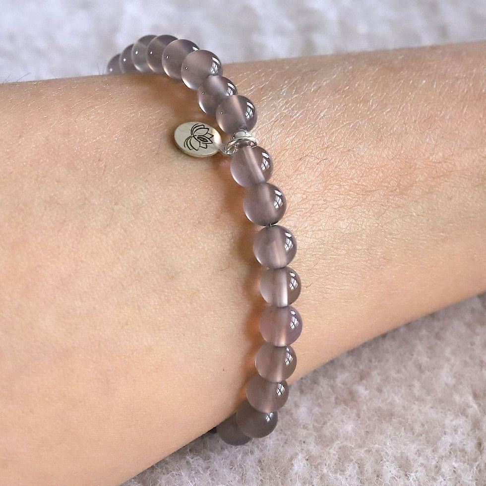 Wearing a silky Purple Chalcedony bracelet. Gentle purple crystal jewelry for yoga and quiet luxury. Shokoro.