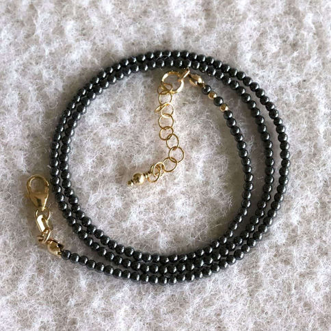 Detailed view of 2mm Hematite beads with 14k gold filled extender, artisan gemstone necklace for layering protection.