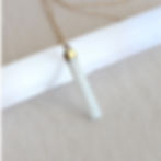 Selenite pendant shown with a raw Selenite wand. High-vibration satin spar crystal for energetic clearing. Shokoro.