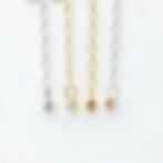 Close-up of sparkling rhinestone charm with long necklace extenders chain in gold and silver for quiet luxury styling