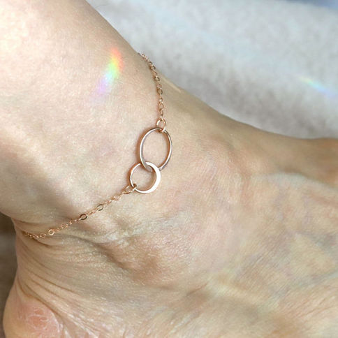 Rose gold double circle anklet, showcasing minimalist elegance in artisan piece, meaningful gift for her reminder.