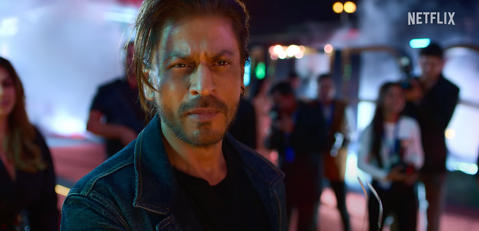 Shah Rukh Khan cameo in Ba**ds of Bollywood Netflix series, dramatic look on red carpet surrounded by media and fans.