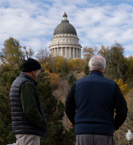 Two people looking at the Utah State Capitol Building