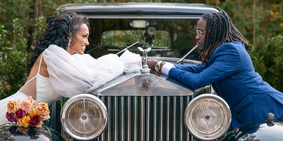 a Black couple holding hands across a vintage car after their wedding posing for va wedding photography