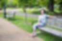 a woman smiling sitting on a park bench | photographer in richmond va