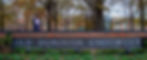 a girl at ODU holds up her decorated graduation cap in front of the school sign for a senior portrait photographer in richmond virginia