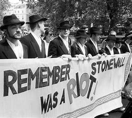 Marchers Holding up a sign that reads " Remember Stone Was a Riot!"