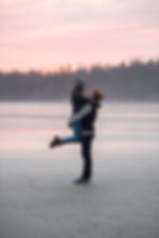 Couple hugs at sunset during their beach engagement photos in Tofino. Photographed by Kaitlyn Shea.