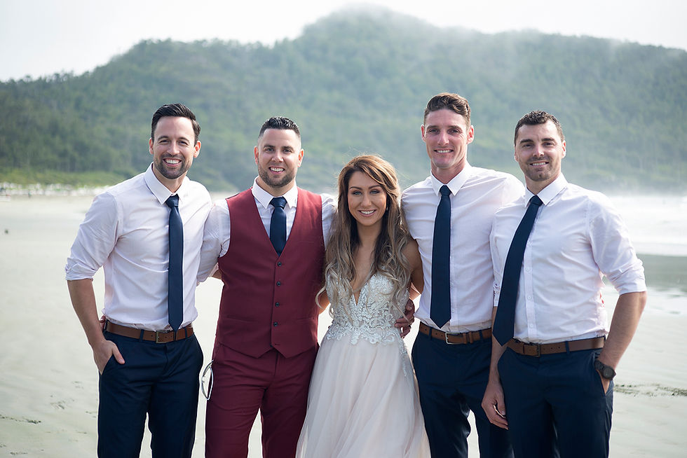 bride and groom and groomsmen at beach wedding in Tofino at Long Beach Lodge. Photographed by Kaitlyn Shea