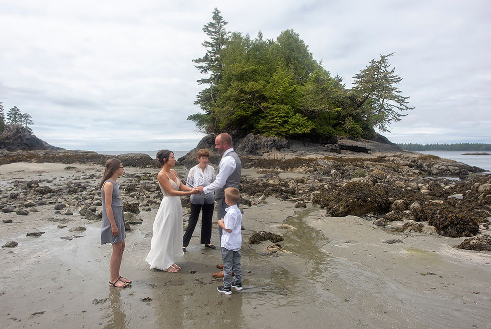 Beach wedding ceremony at an at elopement in Tofino. Photographed by Kaitlyn Shea.