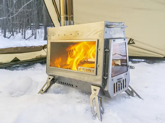 A photo of the Pomoly Dagger stove with a fire inside of it.