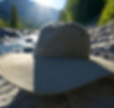 An image of a wide brimmed hat on some rocks.