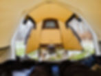 A point of view image from the back of the tent to the front of the tent. My feet and a woodstove are in the image.