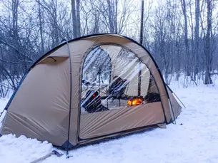 An image of the Pomoly Barracuda 2 tent with woodstove inside