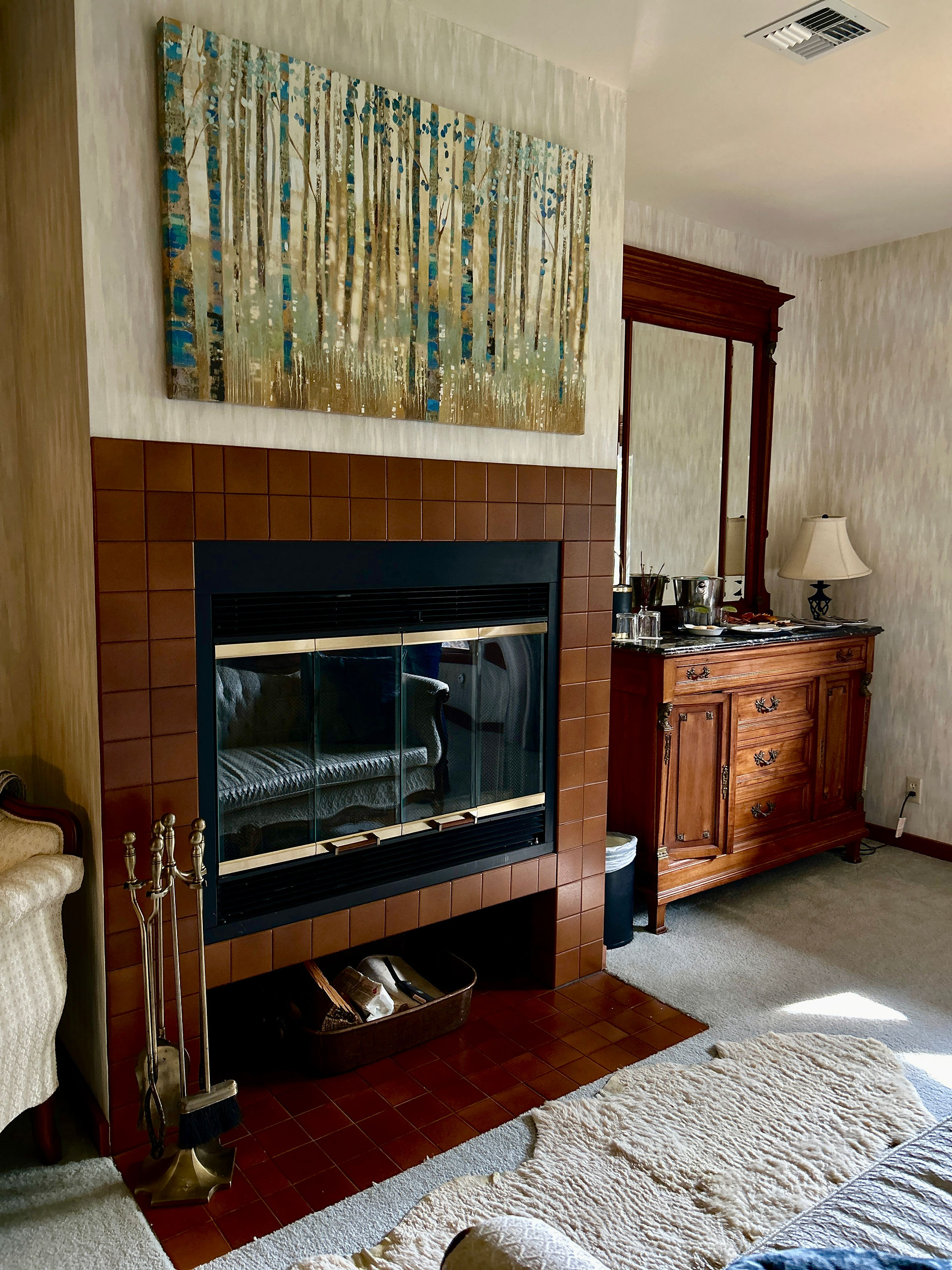 Elegant room with antique French furniture and a fireplace at Casia Lodge & Ranch, a luxury hotel in Twisp, Washington.