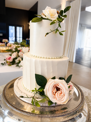 Elegant white wedding cake with floral accents at Westwood, Vowery and Estate in Westfield, Indiana