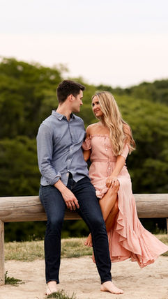Engaged couple sitting together during a scenic outdoor engagement session
