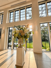 Grand ceremony entrance with floor-to-ceiling windows and floral décor at Westwood, Vowery and Estate in Westfield, Indiana