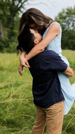 woman embracing fiance in an open field during sunset engagement portraits
