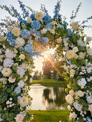 Floral ceremony arch overlooking the water at sunset at Westwood, Vowery and Estate in Westfield, Indiana