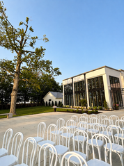 Outdoor wedding ceremony space with white chairs and contemporary venue architecture at Westwood, Vowery and Estate in Westfield, Indiana