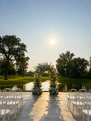 Outdoor wedding ceremony aisle overlooking the water at sunset at Westwood, Vowery and Estate in Westfield, Indiana