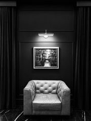 Moody lounge vignette with leather chair and artwork at Westwood, Vowery and Estate in Westfield, Indiana