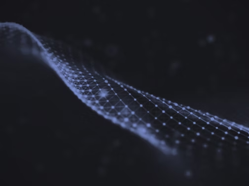 Abstract blue dotted wave flowing across a dark background, suggesting a digital data stream.