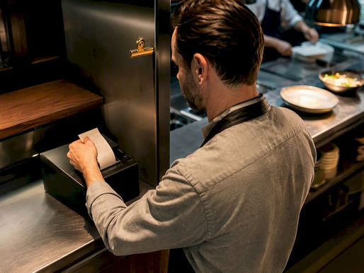 Manager receiving an online restaurant order ticket