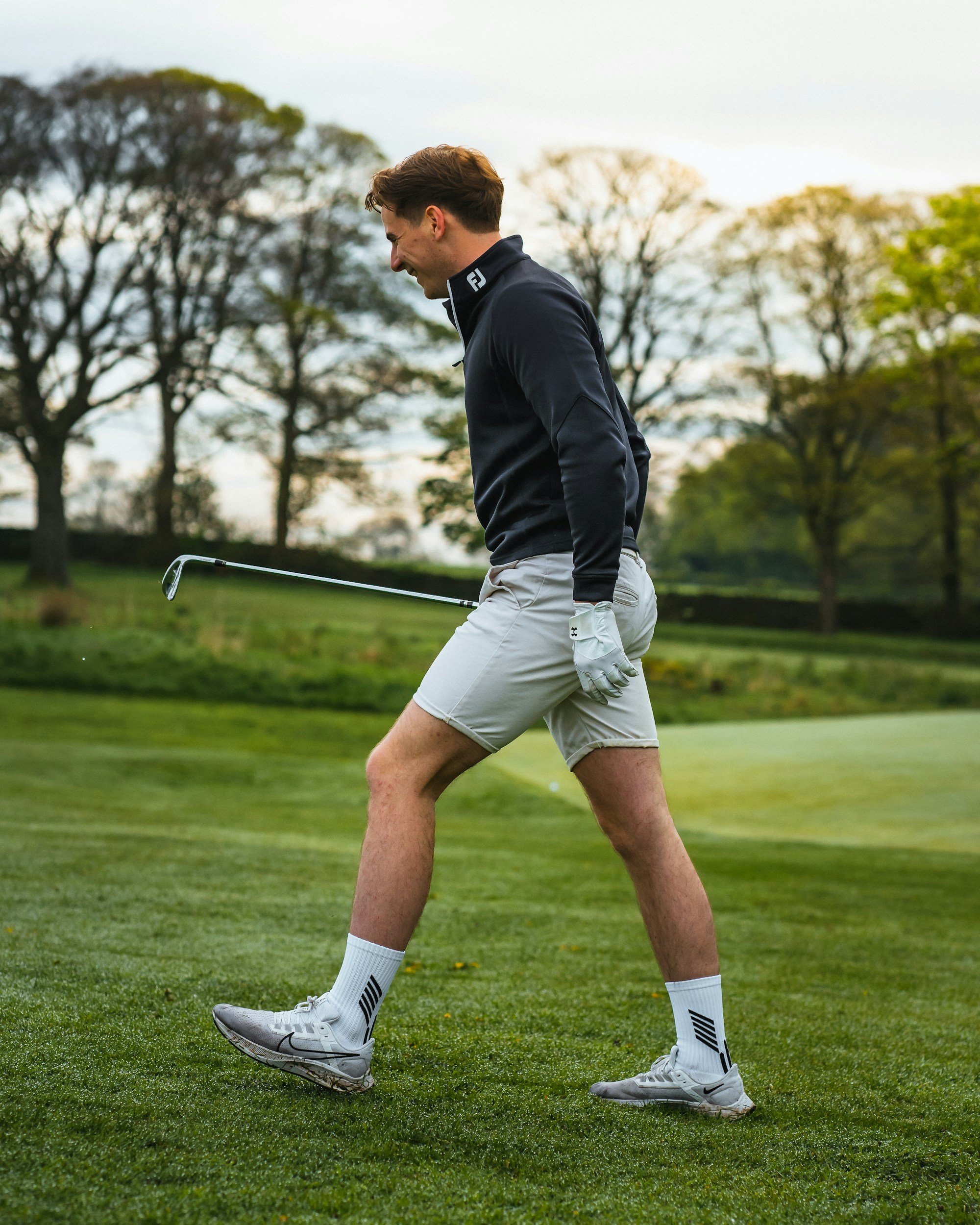 Golfer mid-swing on the course