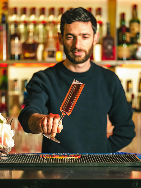A member of the Befikre team behind the bar