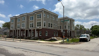 Side angle before image of condo buildings on New York Street, showing faded and aged exterior paint.