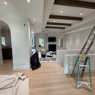 Living room with custom ceiling beams and neutral interior design.