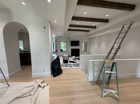 Living room with custom ceiling beams and neutral interior design.