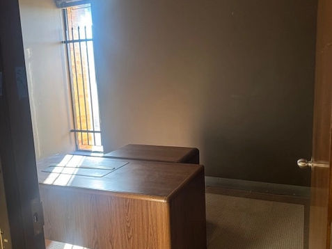 Small office with wooden desk and newly painted walls after water damage restoration.