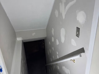 Stair wall with visible wear before prep work for painting.