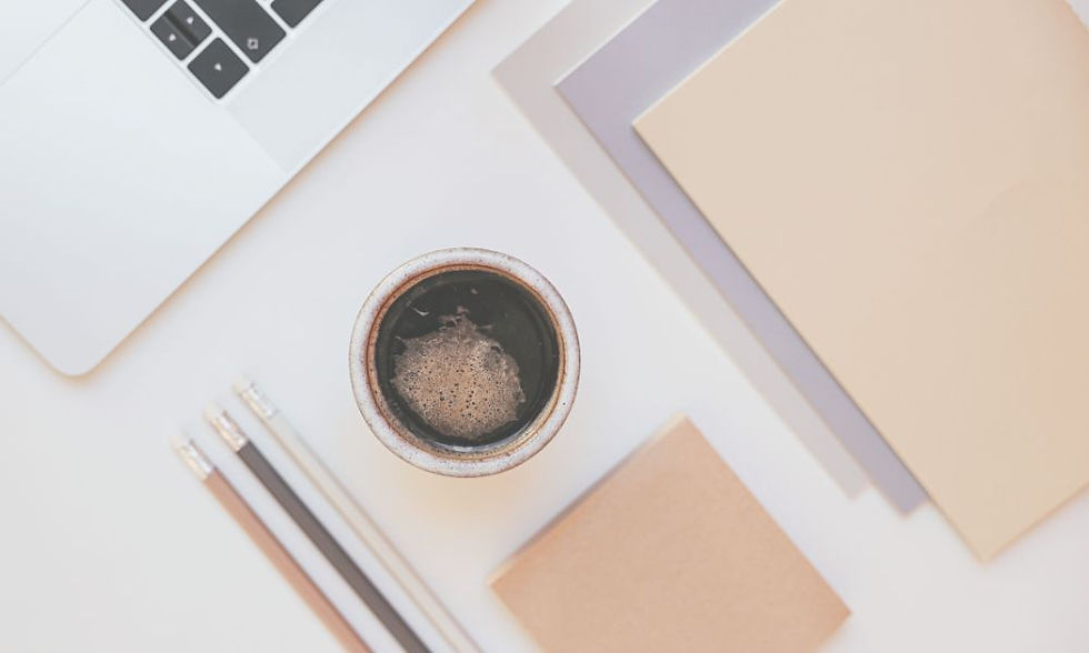 Desk flat lay with pencils, notebooks, laptop, and coffee