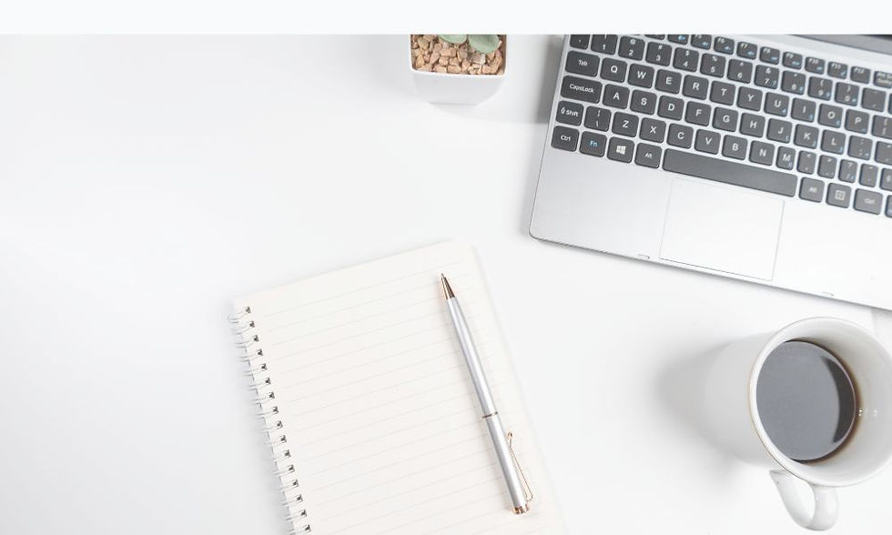 Flat lay with pen and notebook, laptop, and coffee