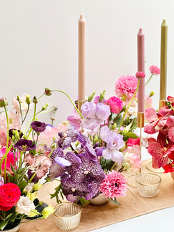 a bunch of pink and purple flowers on a table