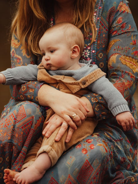 whimsical family photoshoot with mom and baby outside 
