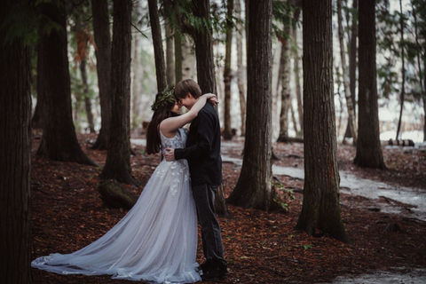 couple embracing in magical forest wedding