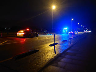 Police and paramedics at scene of motorcycle crash on main road