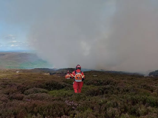 Fire alert issued as wind shifts direction on the fourth day of the extensive Saddleworth moorland fire.