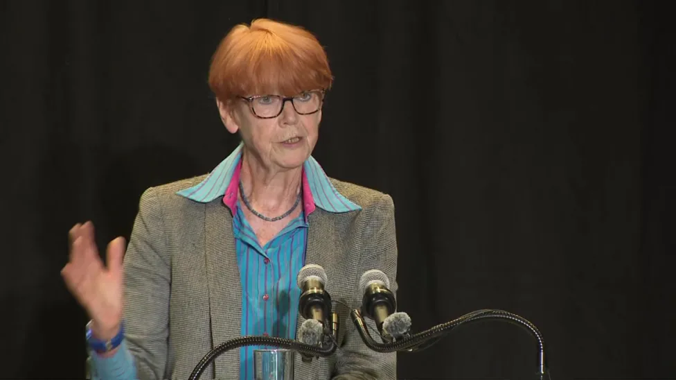 Dame Vera speaking at a press conference discussing the report's findings