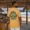 Thumbnail: mustard tee shirt with a green and black British style Pub logo with Old Dudes printed in white letters arching in the center
